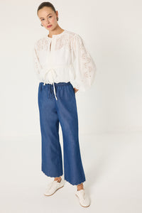 TROUSERS WITH EMBROIDERED HEM